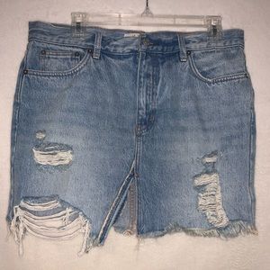 Free People denim skirt with slit down the front.